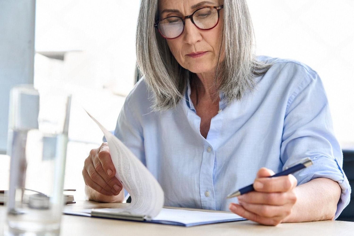 UAE HR manager reviewing company policy documents at her desk