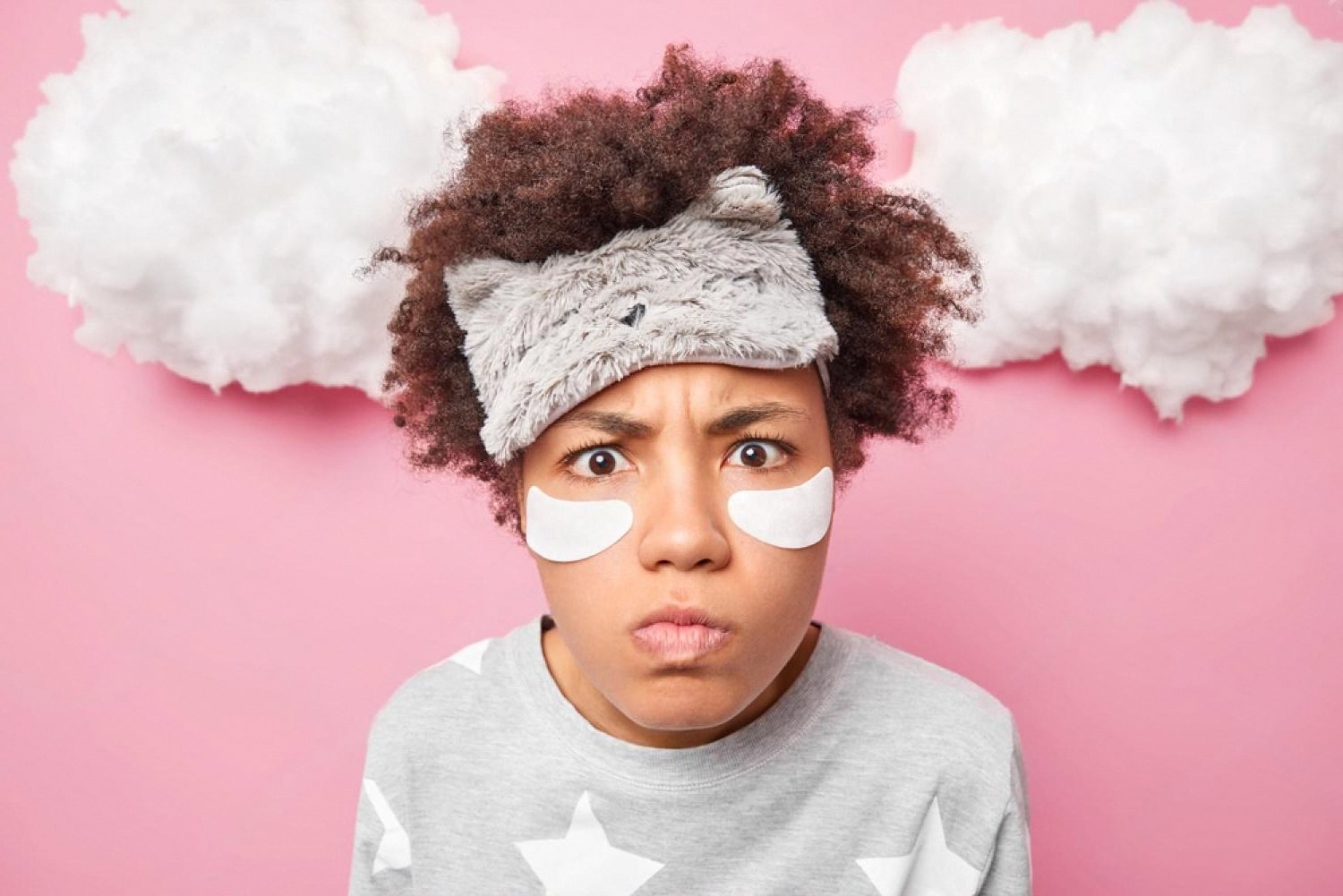 Young woman with irritated skin wearing under-eye patches showing signs of skin barrier damage