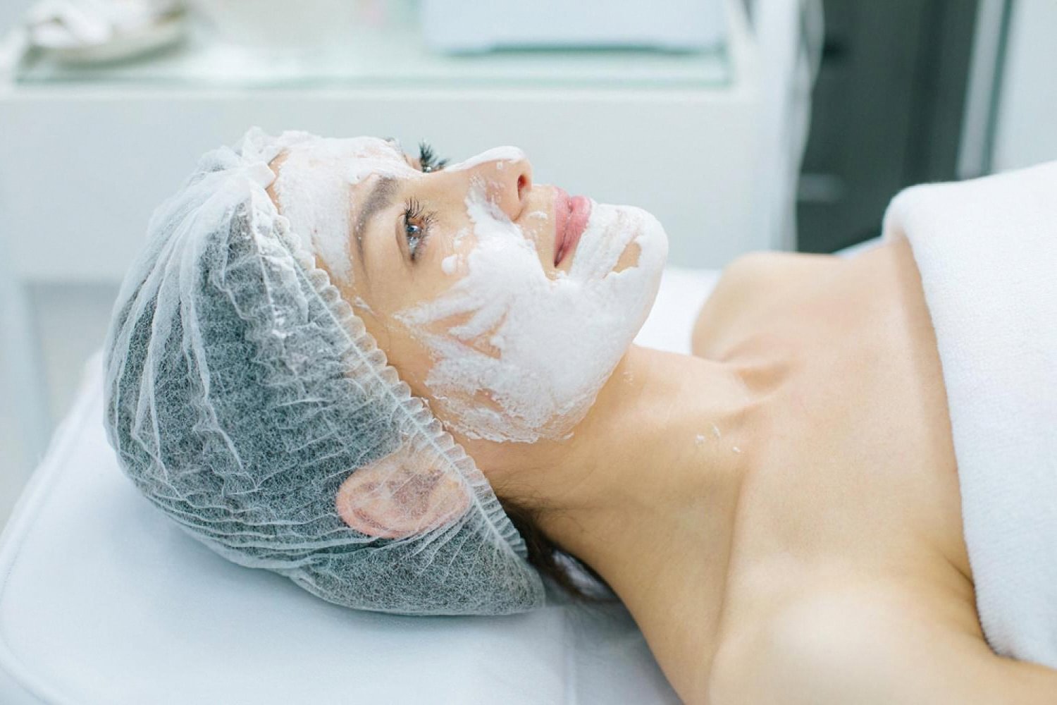Woman receiving a professional facial treatment at a Dubai skincare clinic